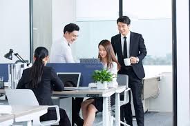 Teacher easily entering grades on a laptop, smiling.